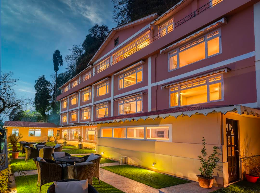 Summit Oakden Resort — illuminated exterior at dusk with garden seating