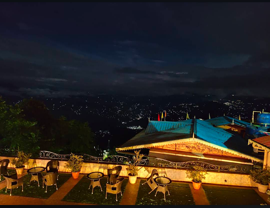 Summit Oakden Resort — rooftop terrace with night city lights view